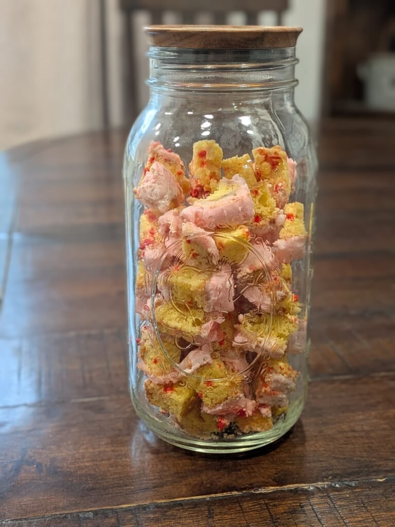 A half-gallon mason jar full of freeze-dried birthday cake bites.