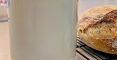 A gallon glass jar with fresh raw milk