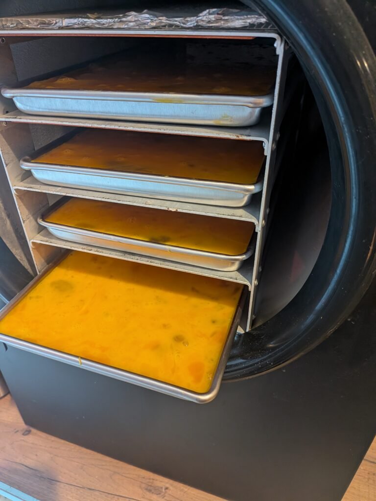 Harvest Right freeze drying machine with 4 trays full of scrambled eggs.
