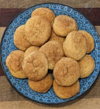 A plate of freshly baked sourdough discard snickerdoodle cookies