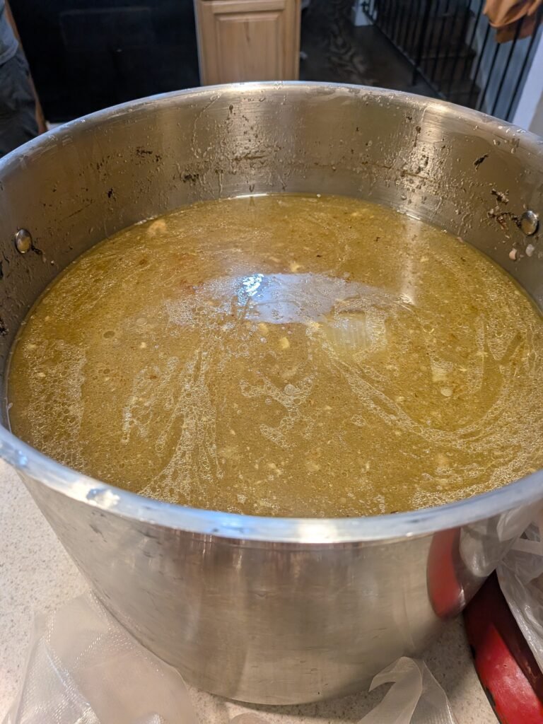 Homemade chicken bone broth in a large stock pot