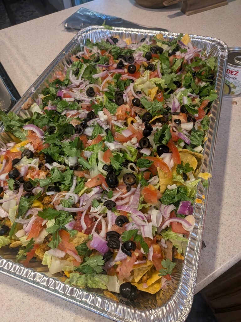 An aluminum tray full of homemade nachos