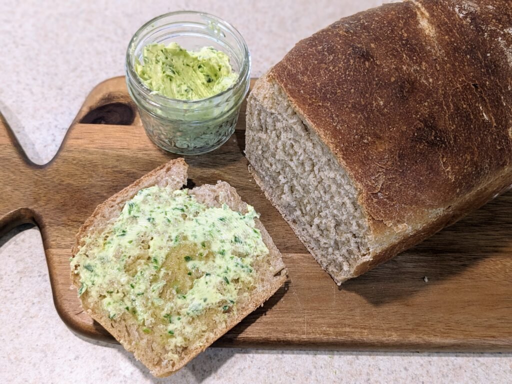 garlic scape butter with a fresh loaf of sourdough bread
