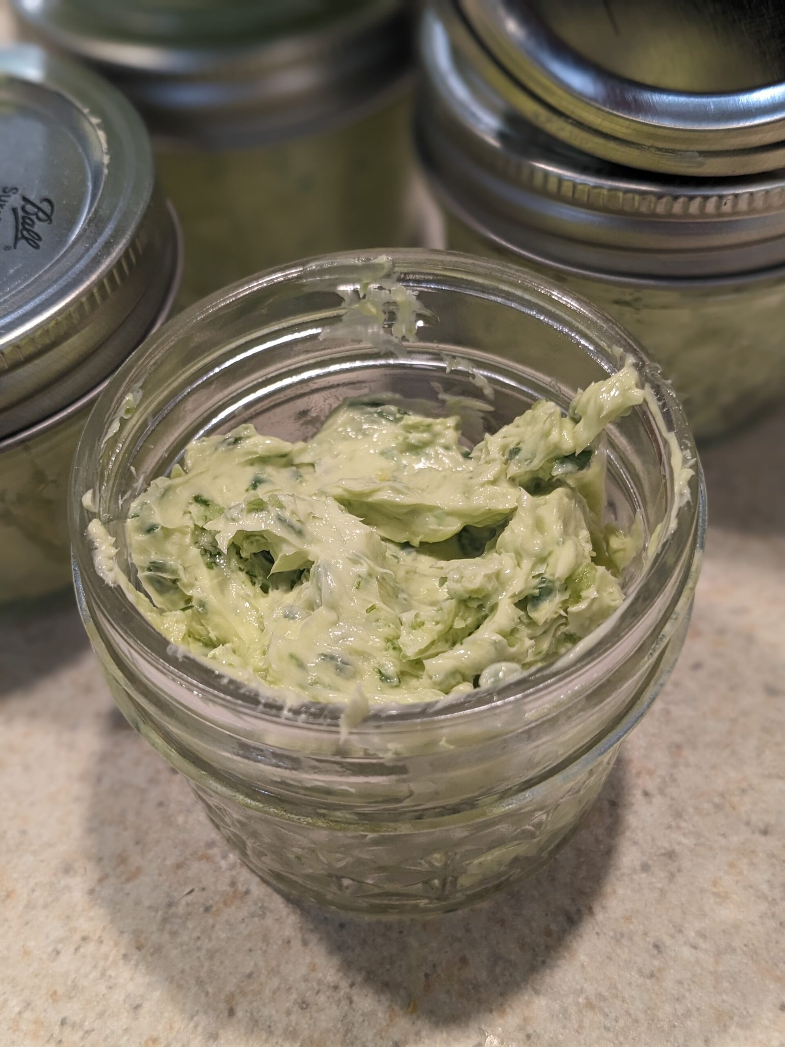 Small mason jar with garlic scape butter